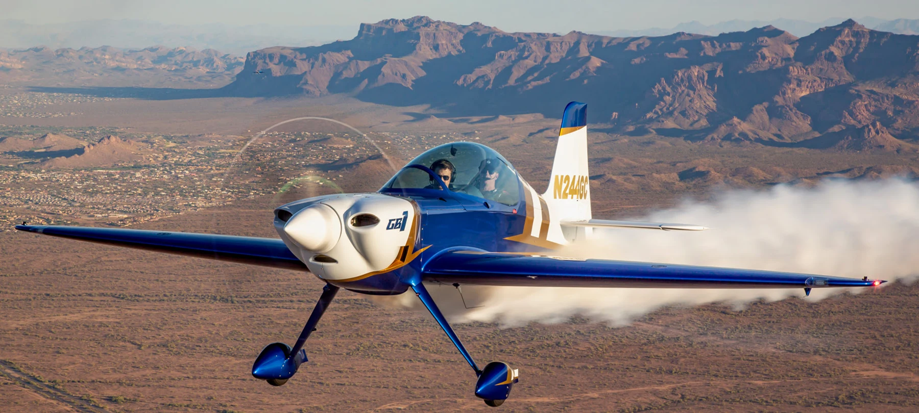 The blue and gold JoyRide GameBird flying over Arizona’s desert mountains